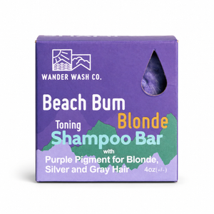 Picture of Wander Wash Co's Beach Bum Blonde Purple Toning Shampoo Bar inside it's Purple Square Box.