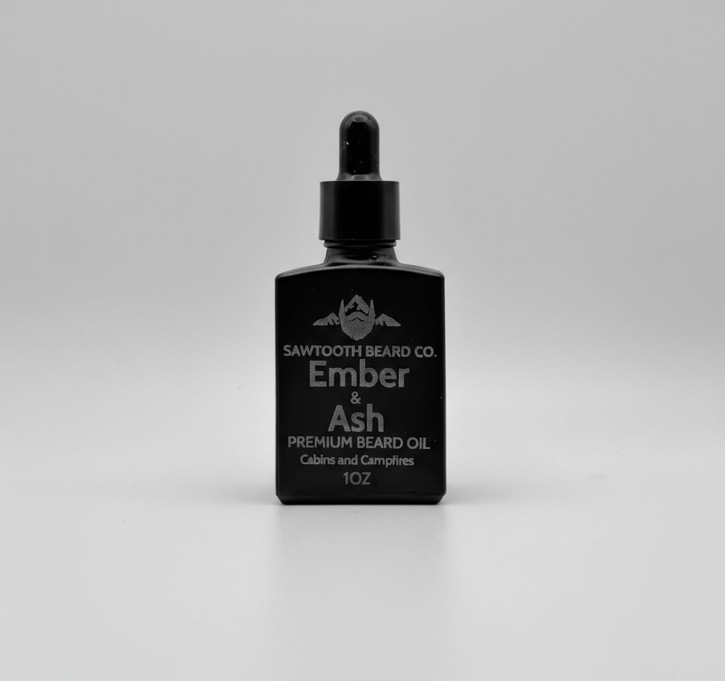 Black bottle of Sawtooth Beard Co Ember & Ash premium beard oil on a gray background