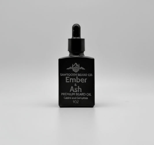 Black bottle of Sawtooth Beard Co Ember & Ash premium beard oil on a gray background