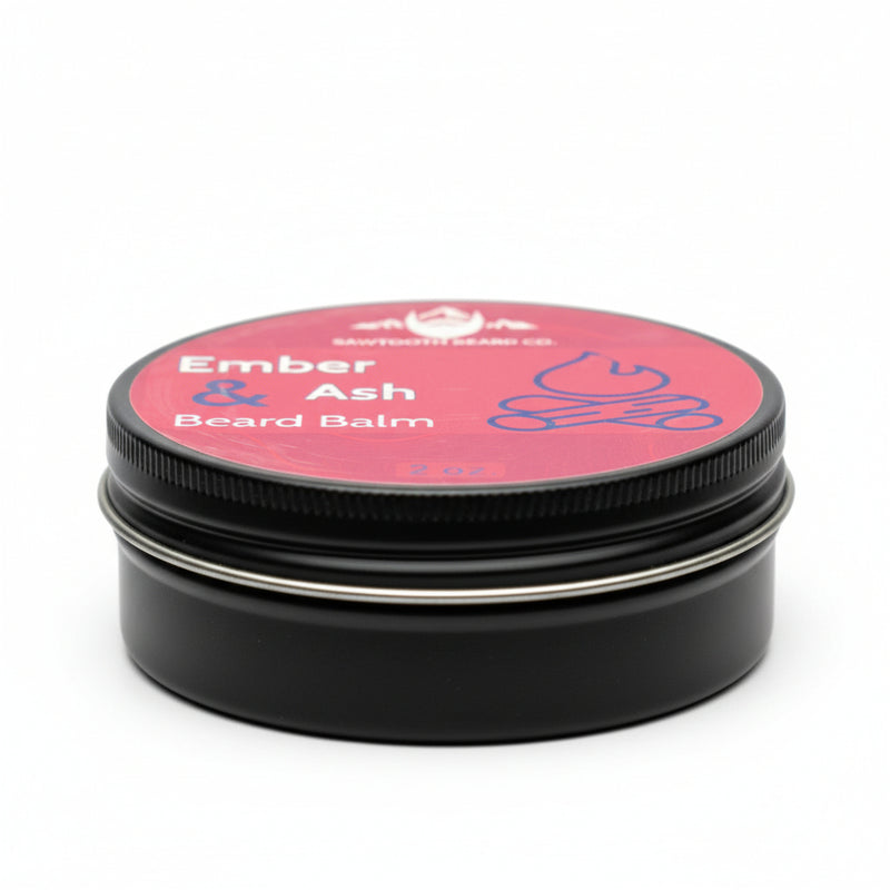 Load image into Gallery viewer, Black tin of Ember &amp; Ash Beard Balm in a black tin with red label on a white background at an angle
