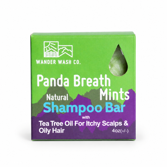 Picture of Wander Wash Co's 
Panda Breath Mints square shampoo bar inside it's Square Green Box with Purple Mountain Accents. 