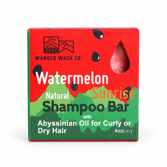 A boxed shampoo bar package for Wander Wash Co. Watermelon Sunrise, featuring a red and green watermelon design with a clear window showing the dark brown shampoo bar inside, on a white background.