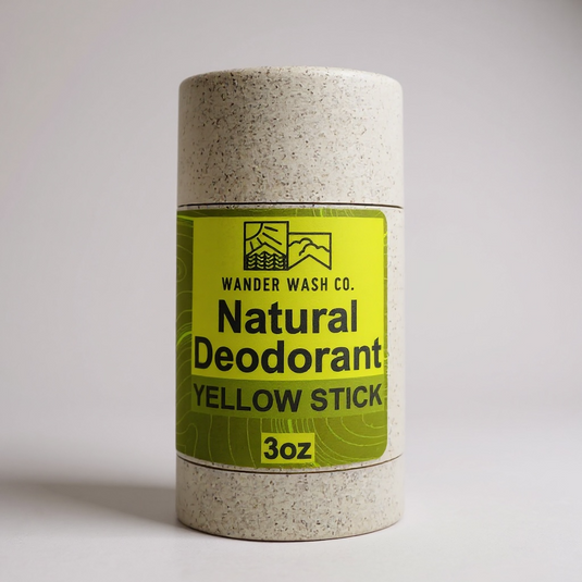 Wander Wash Co. Yellow Stick natural deodorant in a speckled wheat straw tube with a yellow label, 3 oz